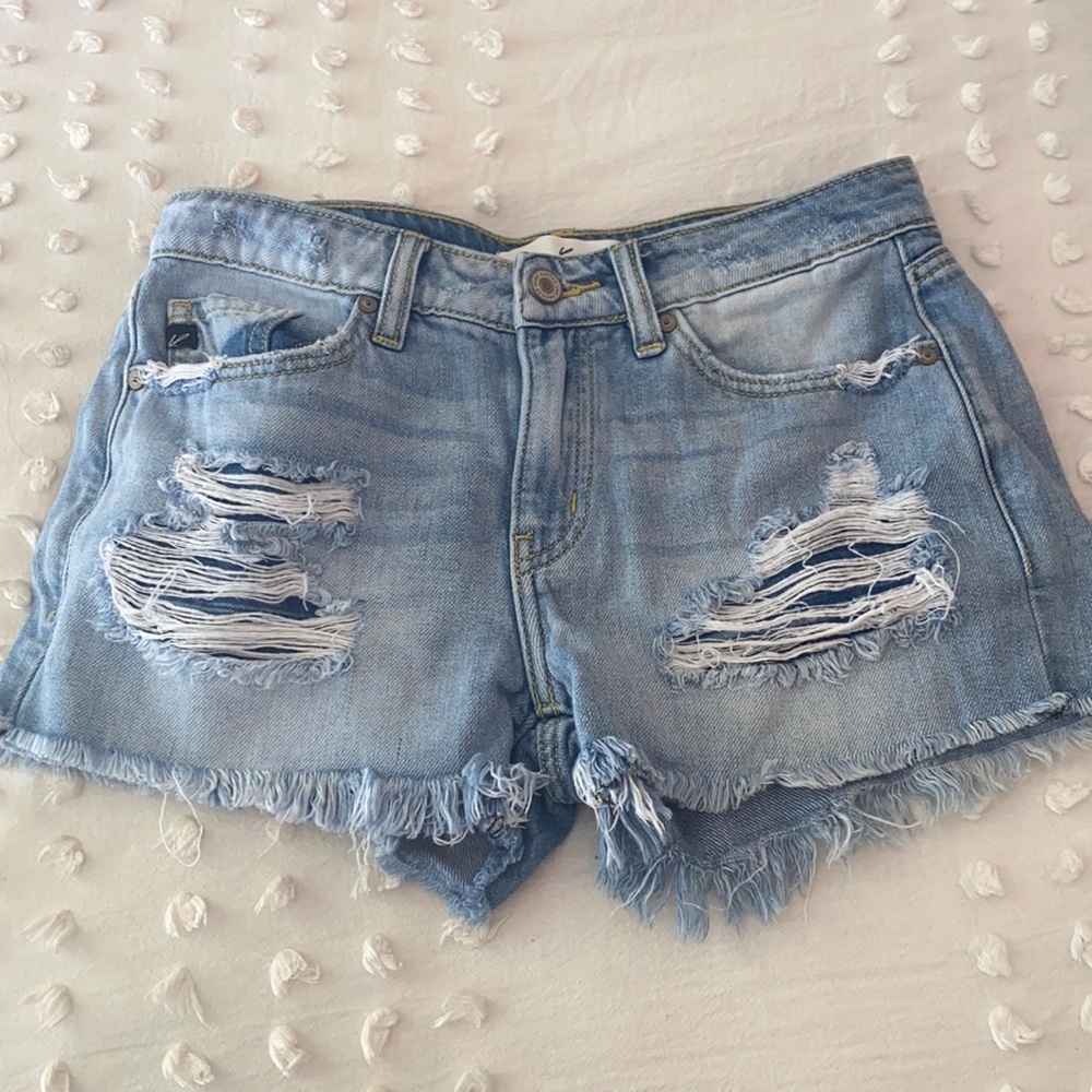 Kancan light wash small shorts with rips.